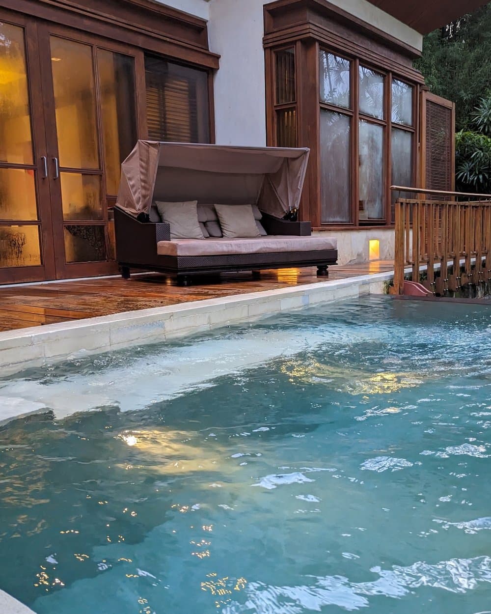 The private plunge pool at dusk, positioned directly above the Ayung River.