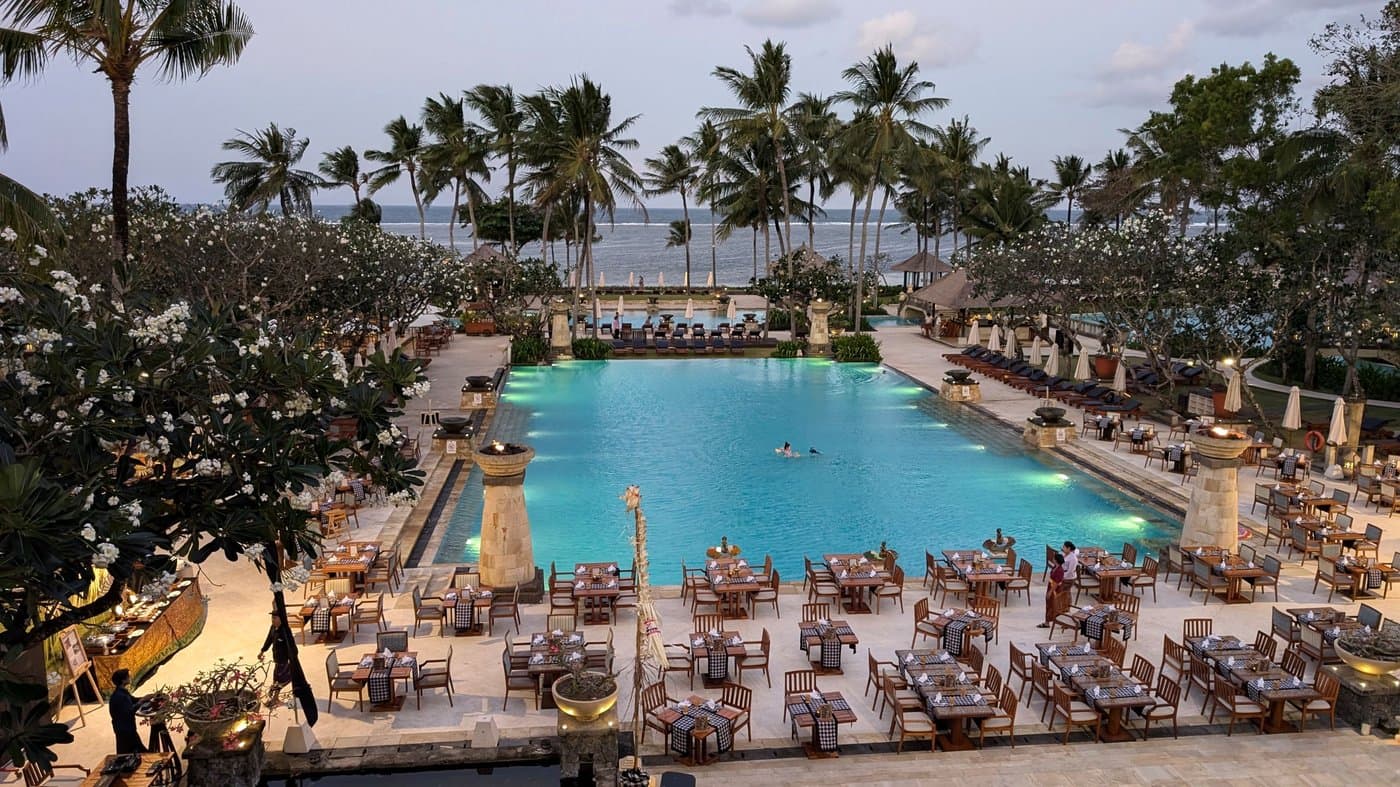 A beachfront resort pool at dusk — one version of what “base yourself well” can look like.